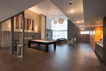 Community lounge with 75” tv for viewing and pool table